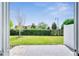 Enclosed backyard featuring green grass, black fence and a concrete patio at 4672 Tribute Trl, Kissimmee, FL 34746