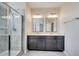 Bright bathroom featuring a glass shower and double vanity with modern fixtures at 4672 Tribute Trl, Kissimmee, FL 34746