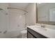 Bathroom featuring a mirror, white shower/tub, toilet, and vanity with black cabinets at 4672 Tribute Trl, Kissimmee, FL 34746