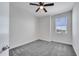 This bedroom features a window with blinds, gray carpet, and white walls at 4672 Tribute Trl, Kissimmee, FL 34746