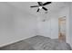 This bedroom features a ceiling fan, gray carpet, white walls, and a closet with bi-fold doors at 4672 Tribute Trl, Kissimmee, FL 34746