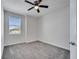 Bedroom featuring neutral carpet, a ceiling fan, and a window with blinds at 4672 Tribute Trl, Kissimmee, FL 34746