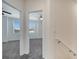Upstairs hallway with view to two bedrooms featuring neutral carpet and white walls at 4672 Tribute Trl, Kissimmee, FL 34746