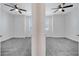 Symmetrical view of two bedrooms with neutral carpet, ceiling fans, and windows at 4672 Tribute Trl, Kissimmee, FL 34746