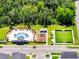 Aerial view of community park with pool, playground, seating, and a soccer field at 4672 Tribute Trl, Kissimmee, FL 34746