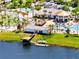 Aerial view of community pool, lazy river, and splash pad featuring many chairs, mature trees, and water views at 4672 Tribute Trl, Kissimmee, FL 34746