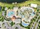 Aerial shot of expansive community pool area with multiple pools, lazy river, and splash pad for residents at 4672 Tribute Trl, Kissimmee, FL 34746