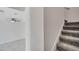 Upstairs hallway with carpeted stairs, tile floor, ceiling fan and white walls at 4672 Tribute Trl, Kissimmee, FL 34746
