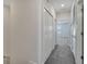 Hallway with gray carpet, white walls, closets, and doors at 4672 Tribute Trl, Kissimmee, FL 34746
