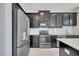 Close-up of the kitchen with stainless steel appliances and sleek black cabinets at 4672 Tribute Trl, Kissimmee, FL 34746