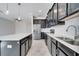 Modern kitchen with stainless steel appliances, large island, and tile backsplash at 4672 Tribute Trl, Kissimmee, FL 34746
