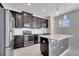 A modern kitchen is complete with stainless steel appliances and a gray wood center island at 4672 Tribute Trl, Kissimmee, FL 34746