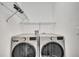 Laundry room featuring a washer, dryer, and shelving at 4672 Tribute Trl, Kissimmee, FL 34746