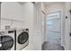 Laundry room featuring a washer and dryer with access to another bedroom at 4672 Tribute Trl, Kissimmee, FL 34746
