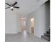 The tile floored living room has access to a bathroom and the carpeted staircase at 4672 Tribute Trl, Kissimmee, FL 34746