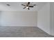 Neutral-toned living area featuring tile floors, white walls, and a ceiling fan for added comfort at 4672 Tribute Trl, Kissimmee, FL 34746