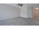 A well-lit living room showcases tile flooring and a ceiling fan, ready for your personal touch at 4672 Tribute Trl, Kissimmee, FL 34746