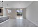 Bright living room with tile flooring, a ceiling fan, and sliding glass doors that lead to the backyard at 4672 Tribute Trl, Kissimmee, FL 34746