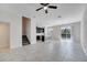 Open-concept living space with tile flooring, a ceiling fan, and sliding glass doors leading to the backyard at 4672 Tribute Trl, Kissimmee, FL 34746