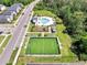 Aerial view of community soccer field, playground, seating, and pool area at 4672 Tribute Trl, Kissimmee, FL 34746