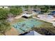 Aerial view of a basketball court in a park with players, landscaping, and nearby recreation area at 4858 S Semoran Blvd # 2108, Orlando, FL 32822