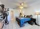 Cozy bedroom featuring tile flooring, ceiling fan, and closet space with adjacent bathroom at 4858 S Semoran Blvd # 2108, Orlando, FL 32822