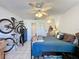 Functional bedroom with ceiling fan, closet, and adjacent bathroom, offering comfortable space at 4858 S Semoran Blvd # 2108, Orlando, FL 32822