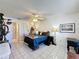 Cozy bedroom featuring tile flooring, ceiling fan, closet space, and lots of natural light at 4858 S Semoran Blvd # 2108, Orlando, FL 32822