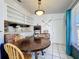 Inviting dining area featuring a wooden table, pendant lighting, and seamless kitchen access at 4858 S Semoran Blvd # 2108, Orlando, FL 32822
