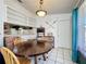 Bright dining room features a wooden table, tile floors, and large window at 4858 S Semoran Blvd # 2108, Orlando, FL 32822