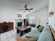 Bright living room with a fireplace, ceiling fan, and a comfortable couch at 4858 S Semoran Blvd # 2108, Orlando, FL 32822