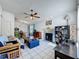 Open-concept living room and dining area with a fireplace and large tile flooring at 4858 S Semoran Blvd # 2108, Orlando, FL 32822