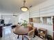 Open floorplan with dining area flows into the living room, filled with natural light at 4858 S Semoran Blvd # 2108, Orlando, FL 32822