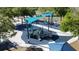 An aerial view showcasing a playground equipped with a slide, climbing structure, and a shaded seating area at 4858 S Semoran Blvd # 2108, Orlando, FL 32822