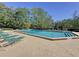 Community pool area with lounge chairs, offering residents a perfect spot for relaxation and outdoor enjoyment at 4858 S Semoran Blvd # 2108, Orlando, FL 32822