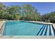 Inviting community pool with lounge chairs and lush green surroundings, ideal for relaxation and recreation at 4858 S Semoran Blvd # 2108, Orlando, FL 32822