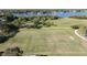 An aerial view of a vibrant soccer field near a beautiful lake, with players engaging in a game at 4858 S Semoran Blvd # 2108, Orlando, FL 32822