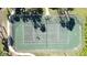Aerial view of community tennis court with palm trees and sidewalks at 4858 S Semoran Blvd # 2108, Orlando, FL 32822