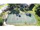 Aerial view of tennis court surrounded by palm trees and sidewalks in a gated community at 4858 S Semoran Blvd # 2108, Orlando, FL 32822