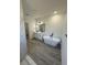 Modern bathroom featuring a soaking tub, double vanity, and sleek gray flooring, offering a spa-like experience at 4863 Sw 159Th Ln Rd, Ocala, FL 34473