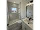 Bathroom with tiled shower featuring black fixtures and modern vanity with granite countertop at 4863 Sw 159Th Ln Rd, Ocala, FL 34473