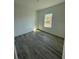 Bright, empty bedroom with modern wood-look floors and a window at 4863 Sw 159Th Ln Rd, Ocala, FL 34473