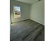 Empty bedroom showcasing wood-look floors and a window view at 4863 Sw 159Th Ln Rd, Ocala, FL 34473