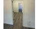 Hallway view leading to bathroom with modern wood-look flooring at 4863 Sw 159Th Ln Rd, Ocala, FL 34473