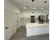 Well-lit kitchen with a large island, stainless steel appliances, quartz countertops, and white cabinets at 4863 Sw 159Th Ln Rd, Ocala, FL 34473