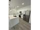 Modern kitchen featuring stainless steel appliances, white cabinets, quartz countertops and modern pendant lighting at 4863 Sw 159Th Ln Rd, Ocala, FL 34473