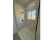 Modern shower with white marble tile and black hardware, plus a window for natural light at 4863 Sw 159Th Ln Rd, Ocala, FL 34473