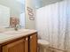 This bathroom features a shower and tub combination with neutral colors at 501 Heartwell Dr, Poinciana, FL 34759