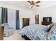 This bedroom features a ceiling fan, dresser, and an open door to the ensuite at 501 Heartwell Dr, Poinciana, FL 34759