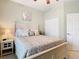 This bedroom features a light color palette and a double closet at 501 Heartwell Dr, Poinciana, FL 34759
